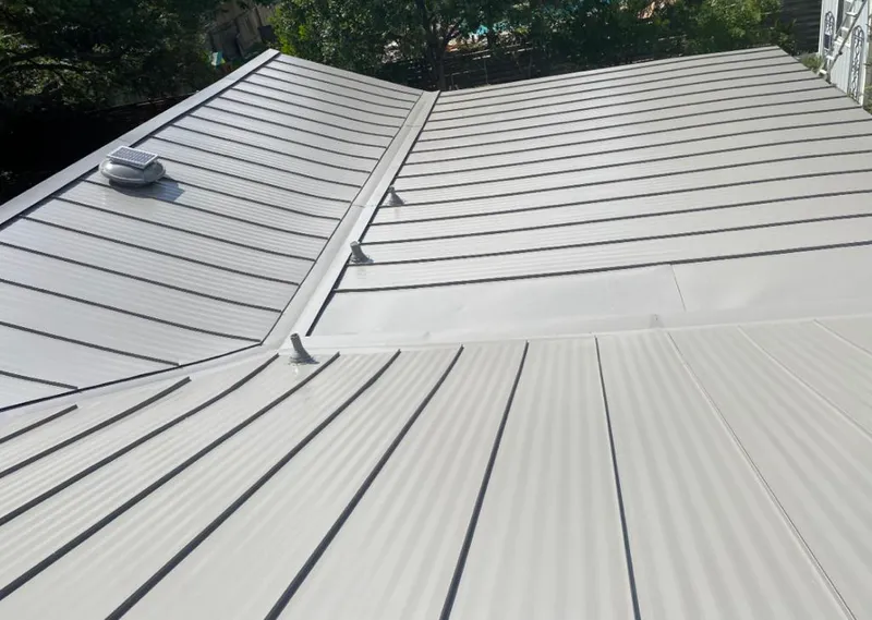 Solar attic fan installed on a metal roof for Roof Ventilation in Lochbuie
